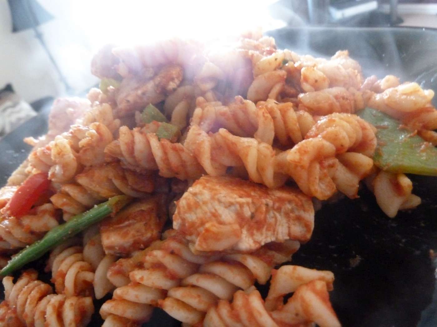 A hearty chicken and bacon pasta bake featuring a rich red sauce